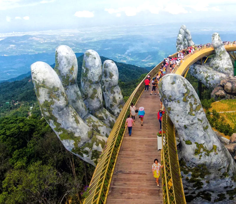 A giant hand holding up a bridge in the clouds